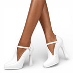 White high-heeled shoes with a strap on a white background